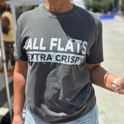 Person wearing a gray t-shirt with 'ALL FLATS EXTRA CRISPY' text.
