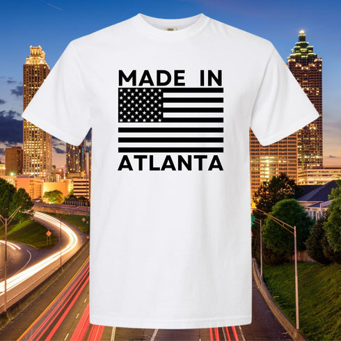 White t-shirt with 'Made in Atlanta' design against a cityscape background