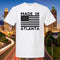 White t-shirt with 'Made in Atlanta' design against a cityscape background