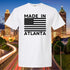 White t-shirt with 'Made in Atlanta' design against a cityscape background