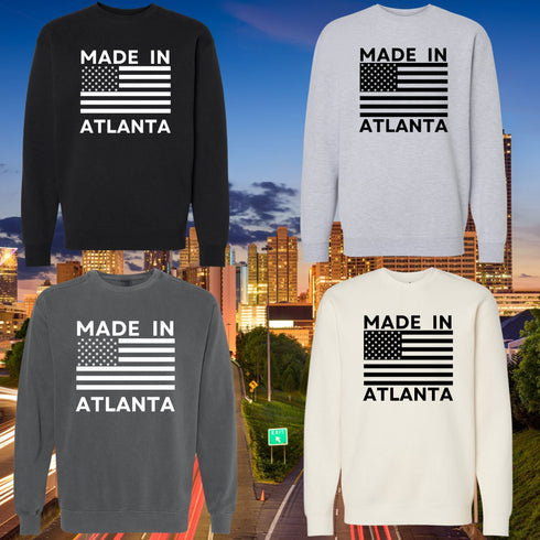 Four sweatshirts with 'Made in Atlanta' text and American flag design against a cityscape background.