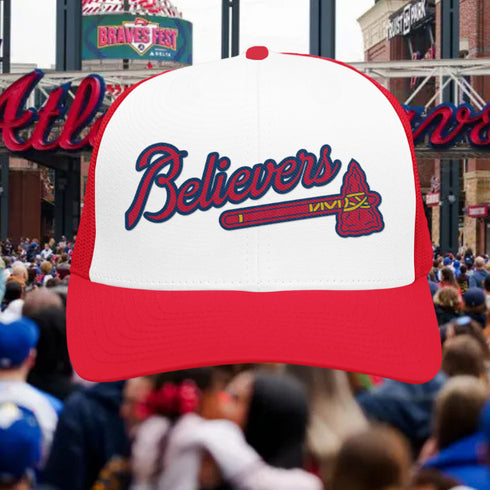 Red and white cap with 'Believers' text and logo over a crowd at a sports event.