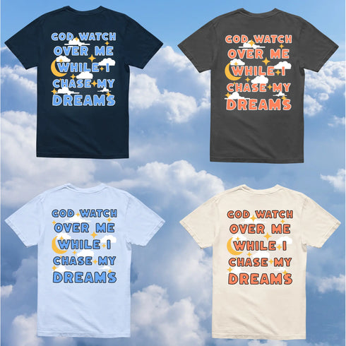 Four t-shirts in navy blue, hydrangea blue, pepper gray, and ivory with motivational text design against a cloudy sky background