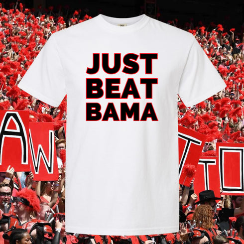 White t-shirt with 'JUST BEAT BAMA' text in front of a crowd background