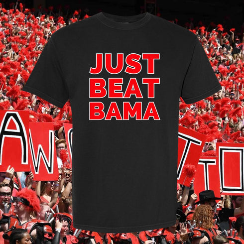 Black t-shirt with 'JUST BEAT BAMA' text in red, set against a background of people holding signs.