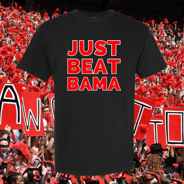 Black t-shirt with 'JUST BEAT BAMA' text in red, set against a background of people holding signs and cheering.