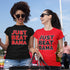 Two women outside tailgating wearing 'Just Beat Bama' t-shirts, one shirt is red, and the other shirt is black.