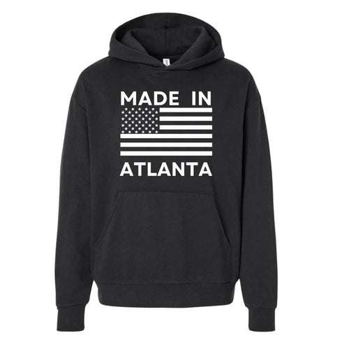 Black hoodie with 'Made in Atlanta' text and American flag design on a white background