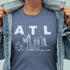Person wearing a blue t-shirt with 'ATL' and a city skyline graphic.