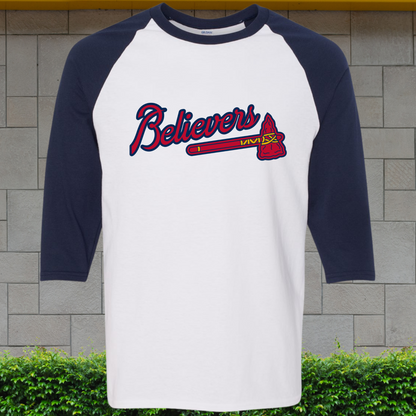 Navy and white baseball shirt with 'Believers' text on a stone wall background
